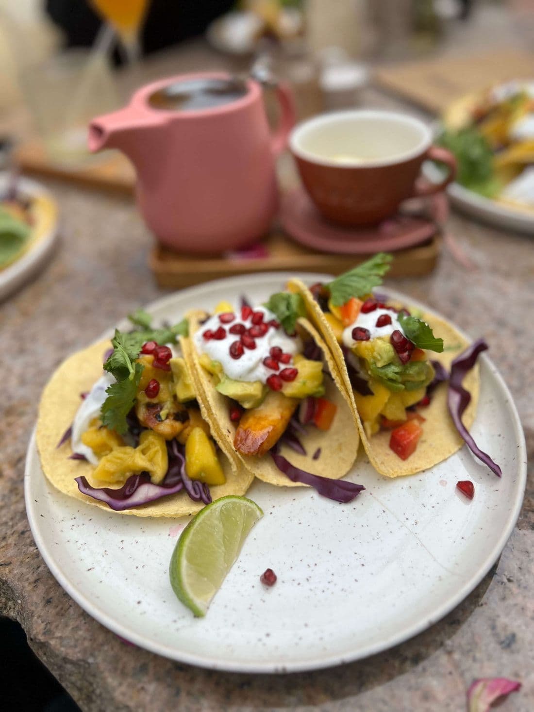 Tacos with mango salsa and lime on a plate